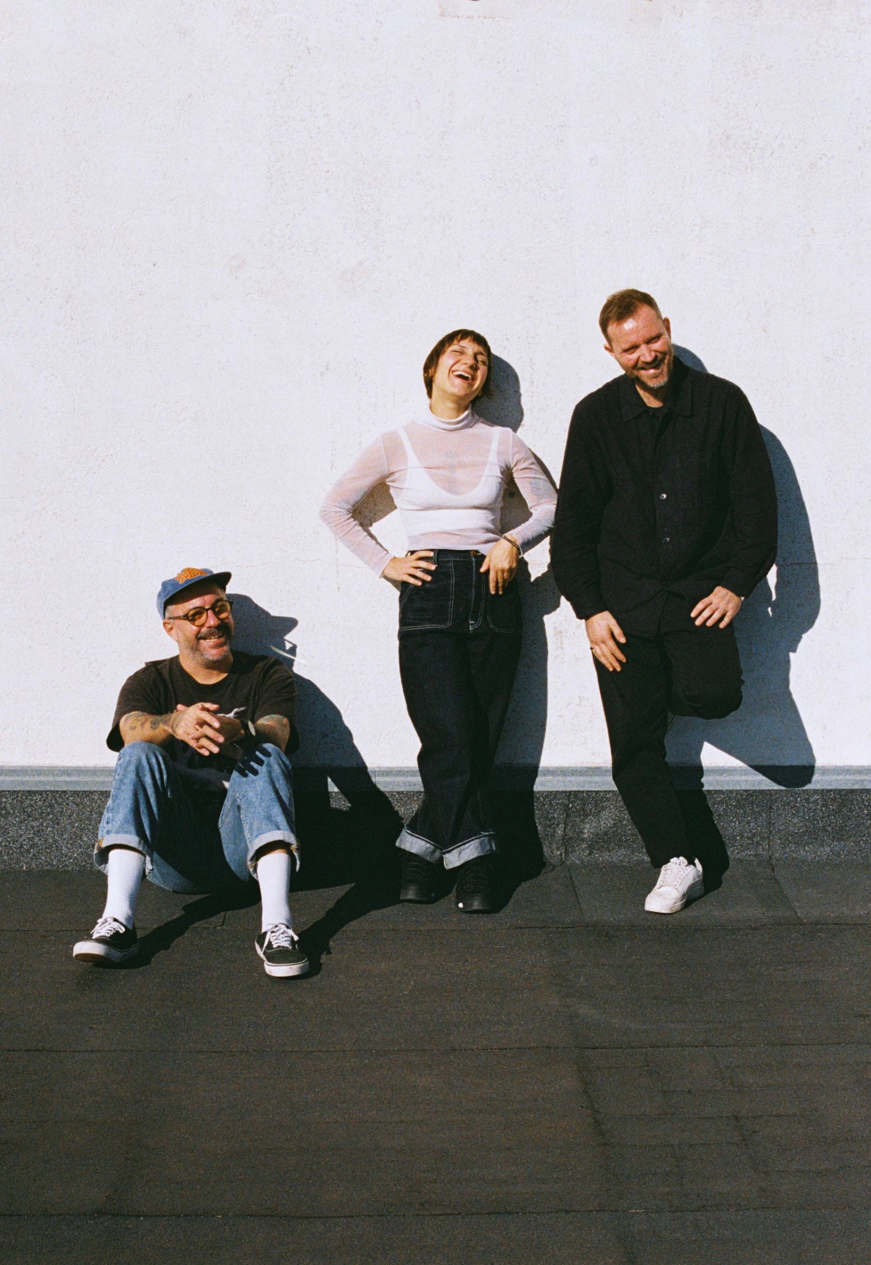 The three Niceshit founders photographed together against a white wall.
